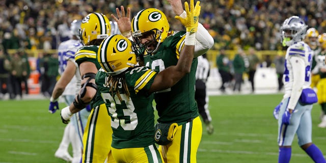 Aaron Jones celebrates with Aaron Rodgers