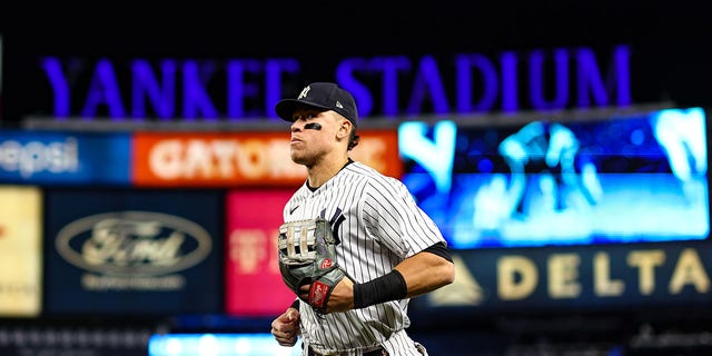Aaron Judge of the New York Yankees runs to the dugout during Game 4 of the American League Championship Series against the Houston Astros at Yankee Stadium on Oct. 23, 2022, in New York.