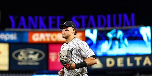 Aaron Judge of the New York Yankees runs to the dugout during Game 4 of the American League Championship Series against the Houston Astros at Yankee Stadium on Oct. 23, 2022, in New York.