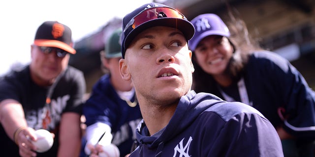 New York Yankees' Aaron Judge signs autographs before a game against the San Francisco Giants at Oracle Park, April 27, 2019, in San Francisco.