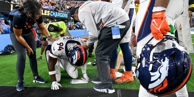 Aaron Patrick of the Denver Broncos kneels on the ground after colliding with a sideline worker during a "Monday Night Football" game at SoFi Stadium in Inglewood, California, on Oct. 17, 2022.