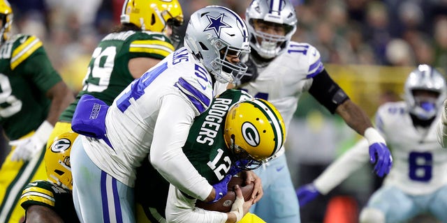 Green Bay Packers quarterback Aaron Rodgers is sacked by Dallas Cowboys defensive end Sam Williams during the second half, Nov. 13, 2022, in Green Bay, Wisconsin.