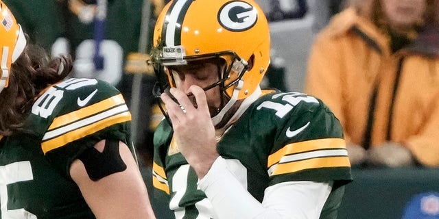 The Green Bay Packers' Aaron Rodgers walks off the field after fumbling while being sacked during the first half of a game against the Dallas Cowboys in Green Bay, Wisconsin, on Nov. 13, 2022.