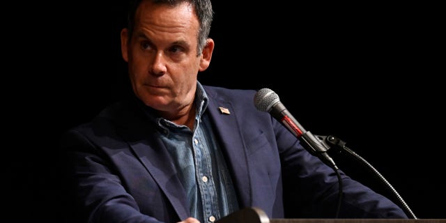 FILE: Democrat House Candidate Adam Frisch listens to incumbent U.S. Congresswoman Lauren Boebert during a debate at Colorado Mesa University as part of The Club 20 political conference on September 10, 2022, in Grand Junction, Colorado. 