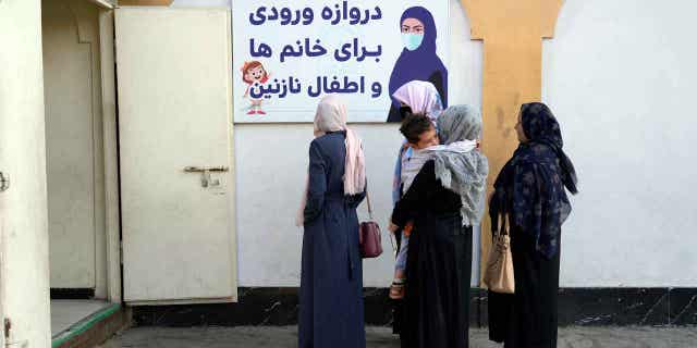 Afghan women stand outside an amusement park, in Kabul, Afghanistan, on Nov. 10, 2022. The Taliban has banned women from using gyms and parks in Afghanistan, on Nov. 10, 2022. The U.N. General Assembly has come to a resolution regarding the Taliban committing human rights violations against women in Afghanistan.