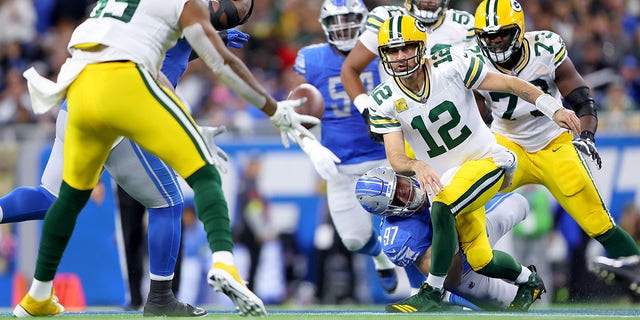 Aidan Hutchinson (97) of the Detroit Lions tackles Aaron Rodgers (12) of the Green Bay Packers during the first half at Ford Field Nov. 6, 2022, in Detroit.