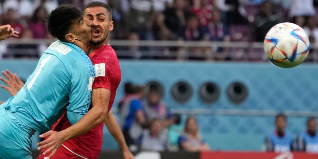 Iran's goalkeeper Alireza Beiranvand, left, collides with Iran's Majid Hosseini, right, during the World Cup group B soccer match between England and Iran at the Khalifa International Stadium in Doha, Qatar, Monday, Nov. 21, 2022.