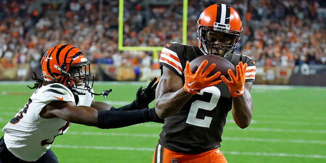 Cleveland Browns wide receiver Amari Cooper, #2, catches a pass from quarterback Jacoby Brissett for a touchdown with Cincinnati Bengals cornerback Tre Flowers, #33, defending during the second half of an NFL football game in Cleveland, Monday, Oct. 31, 2022. 