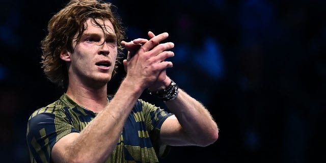 Andrey Rublev acknowledges the public after winning his match against Daniil Medvedev on Nov. 14, 2022, in Turin.