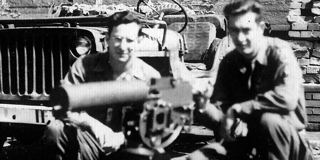 Andy Andrews, left, and a fellow soldier with a machine gun and Jeep.