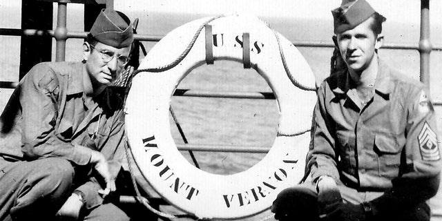 Andy Andrews, left, with a friend aboard the USS Mount Vernon in October 1945.