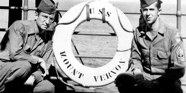 Andy Andrews, left, with a friend aboard the USS Mount Vernon in October 1945.