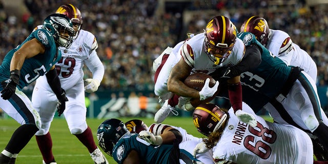 Antonio Gibson of the Washington Commanders scores a touchdown against the Eagles on Nov. 14, 2022, in Philadelphia.