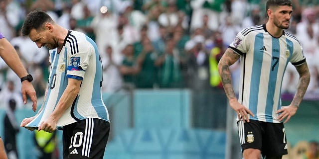Argentina's Lionel Messi, left, and Argentina's Rodrigo De Paul react during the World Cup group C soccer match between Argentina and Saudi Arabia at Lusail Stadium in Lusail, Qatar, Tuesday, November 22, 2022.