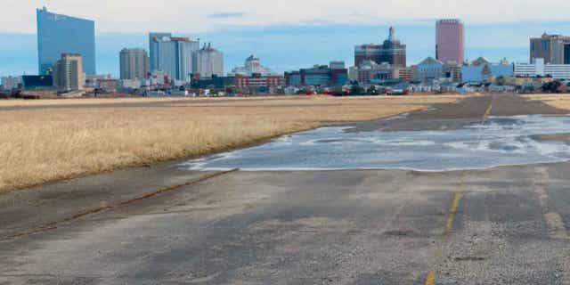 A runway at the former Bader Field airport site is backdropped by casinos on Feb. 18, 2022, in Atlantic City, New Jersey. Two developers from Philadelphia, Post Brother and Tower Development, want to build a $3 billion housing, office, and retail project in Atlantic City at the former airport.