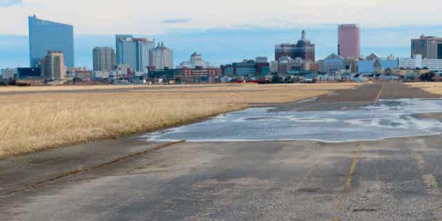 A runway at the former Bader Field airport site is backdropped by casinos on Feb. 18, 2022, in Atlantic City, New Jersey. Two developers from Philadelphia, Post Brother and Tower Development, want to build a $3 billion housing, office, and retail project in Atlantic City at the former airport.
