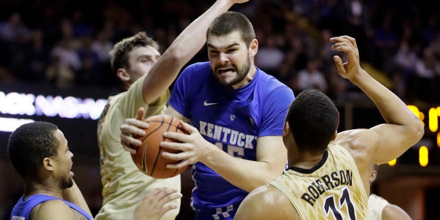 Kentucky forward Isaac Humphries, center, grabs a rebound in front of Vanderbilt's Luke Kornet, second from left, and Jeff Roberson (11) during the first half of an NCAA college basketball game on Jan. 10, 2017, in Nashville, Tenn. Melbourne United starting center Isaac Humphries has announced that he is gay and said he hopes his decision to publicly announce his sexuality will lead to more professional sportsmen doing the same.