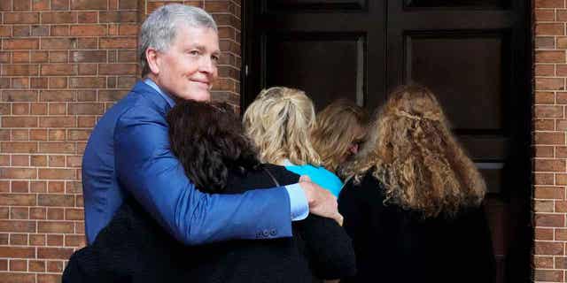 Steve Johnson, brother of U.S. murder victim Scott Johnson, hugs his wife Rosemarie as they arrive at the Supreme Court in Sydney, on May 2, 2022, for a sentence hearing. A government inquiry began hearing evidence on Nov. 2, 2022, of unsolved deaths resulting from gay hate crime over four decades.