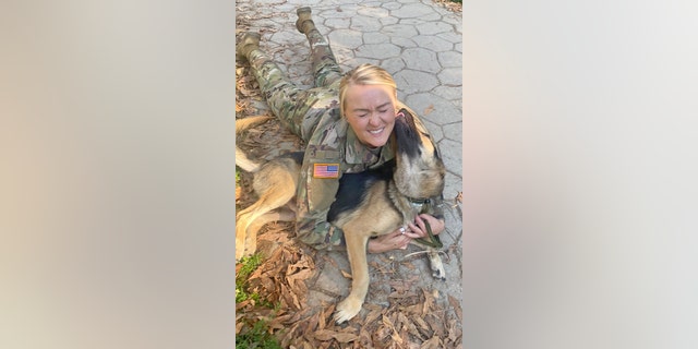 Staff Sgt. Andrea Taulton, who was deployed to Kosovo, gets kisses from the rescue pup, Axel, that she's trying to bring home to America.