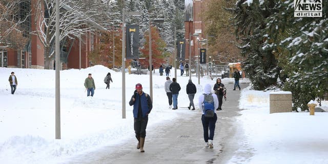 Students walk around the University of Idaho campus after four of their co-eds were murdered before Thanksgiving 2022.