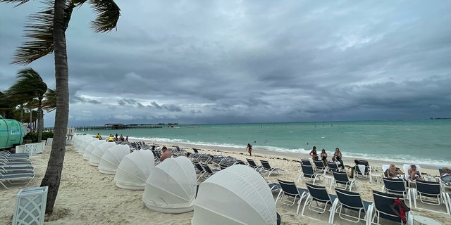 Wind blows palm leaves on an overcast day at the Baha Mar resort's beach on New Providence Island in the Bahamas.