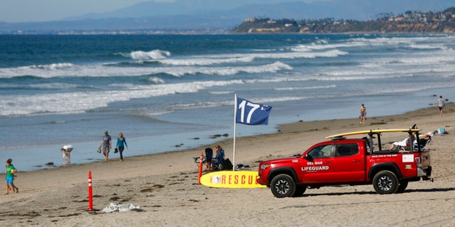 A lifeguard truck is seen on Nov. 4, 2022, along Del Mar beach, north of San Diego, after a 50-year-old woman was bitten by a shark in the water prompting a beach closure of at least 48 hours in the area, city lifeguard officials said on Nov. 4, 2022. 