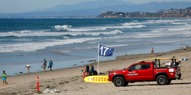 A lifeguard truck is seen on Nov. 4, 2022, along Del Mar beach, north of San Diego, after a 50-year-old woman was bitten by a shark in the water prompting a beach closure of at least 48 hours in the area, city lifeguard officials said on Nov. 4, 2022.