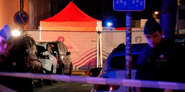 Police attend the scene of an incident in Brussels on Nov. 10, 2022. One police officer is dead and another injured in a stabbing attack in Brussels, which a Belgian judicial official says is suspected to be terrorism-linked.