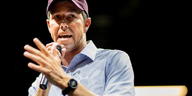 Beto O'Rourke in red hat speaking