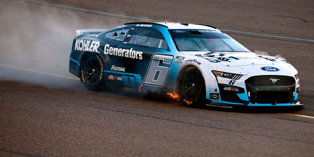 Brad Keselowski, driver of the No. 6 Kohler Generators Ford, drives with flames after an on-track incident during the NASCAR Cup Series Championship at Phoenix Raceway, Nov. 6, 2022, in Avondale, Arizona.