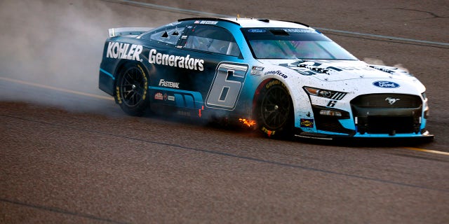 Brad Keselowski, driver of the No. 6 Kohler Generators Ford, drives with flames after an on-track incident during the NASCAR Cup Series Championship at Phoenix Raceway, Nov. 6, 2022, in Avondale, Arizona.