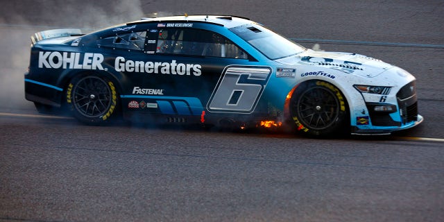 Brad Keselowski, driver of the No. 6 Kohler Generators Ford, drives with flames after an on-track incident during the NASCAR Cup Series Championship at Phoenix Raceway, Nov. 6, 2022, in Avondale, Arizona.