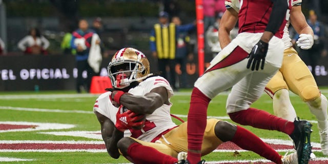 San Francisco 49ers wide receiver Brandon Aiyuk, left, makes a touchdown reception during the first half of an NFL football game against the Arizona Cardinals on Monday, Nov. 21, 2022, in the City from Mexico. 