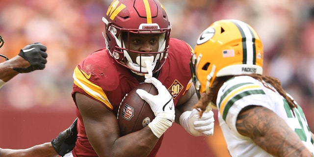 Brian Robinson Jr., #8 of the Washington Commanders, runs with the ball during an NFL football game against the Green Bay Packers at FedEx Field on Oct. 23, 2022 in Landover, Maryland. 