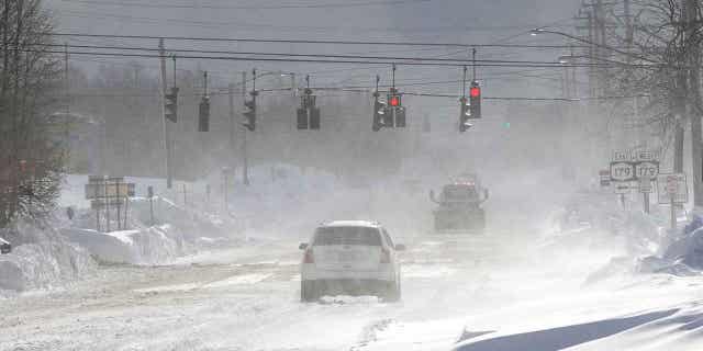 Cars drive through the snow on McKinley Parkway in Erie County, New York, on Nov. 20, 2022.