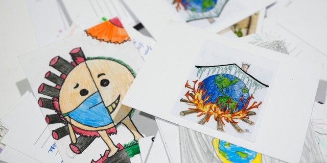Letters and drawings left behind are collected at the Youth Pavilion at the United Nations Climate Summit COP27, Saturday, November 19, 2022, Sharm el-Sheikh, Egypt. 