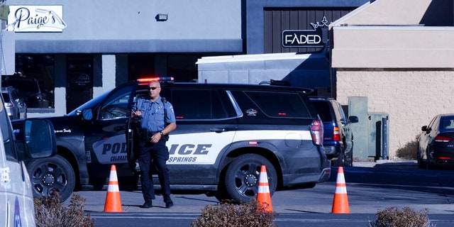 A police officer exits his car near a crime scene at a gay nightclub in Colorado Springs, Colorado on Sunday, Nov. 20, where a shooting occurred late Saturday night.