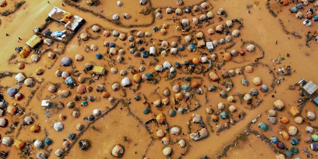 Huts made of branches and cloth provide shelter for Somalis displaced by drought on the outskirts of Dollow, Somalia, on September 19, 2022.