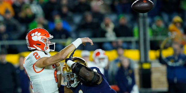 Notre Dame defensive lineman Justin Ademilola pressures Clemson quarterback Cade Klubnik into throwing an interception during the second half of an NCAA college football game Saturday, Nov. 5, 2022, in South Bend, Ind. Notre Dame won 35-14.