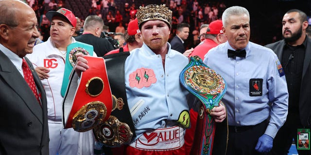 Canelo Alvarez poses with his championship belts after his unanimous decision victory against Gennadiy Golovkin, in a super middleweight title bout  at T-Mobile Arena in Las Vegas, Saturday, Sept. 17, 2022.