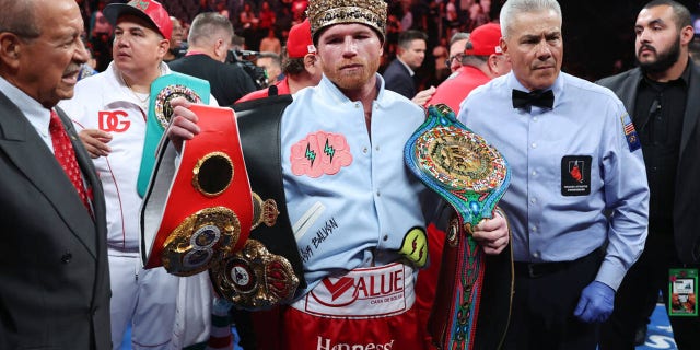 Canelo Alvarez poses with his championship belts after his unanimous decision victory against Gennadiy Golovkin, in a super middleweight title bout at T-Mobile Arena in Las Vegas, Saturday, Sept. 17, 2022.