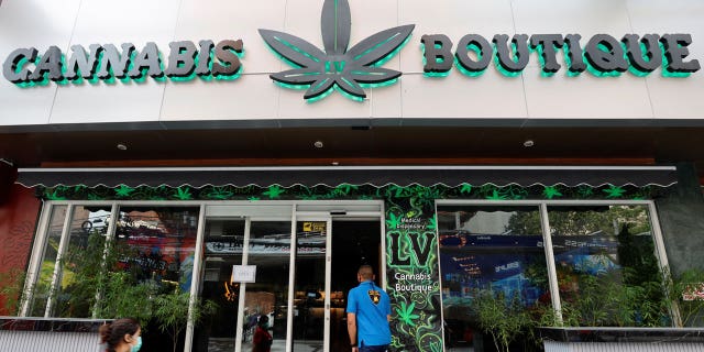 A person enters a cannabis shop near the Asia-Pacific Economic Cooperation Summit venue in Bangkok, Thailand, on November 17, 2022.