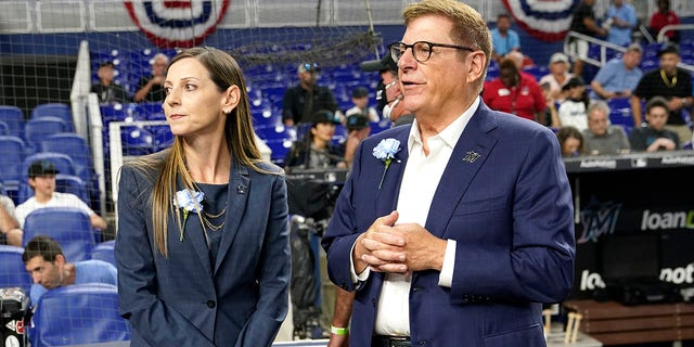 Caroline O'Connor stands with president and original owner Bruce Sherman before a Philadelphia Phillies game on April 14, 2022, in Miami.