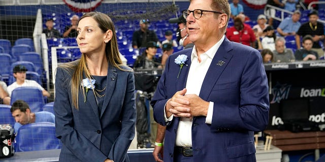 Caroline O'Connor stands with president and original owner Bruce Sherman before a Philadelphia Phillies game on April 14, 2022, in Miami.