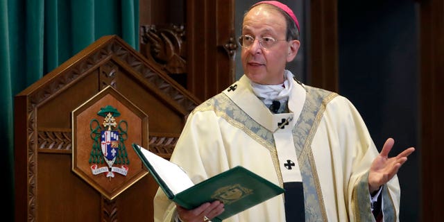 FILE - Baltimore Archbishop William Lori leads a funeral Mass in Baltimore on March 28, 2017.