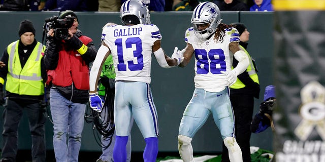 Dallas Cowboys' Michael Gallup (13) and CeeDee Lamb (88) celebrate Lamb's touchdown reception during the second half of an NFL football game against the Green Bay Packers on Sunday, Nov. 13, 2022, in Green Bay , Wisconsin.