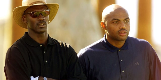 Basketball stars Michael Jordan, left, and Charles Barkley wait to tee off from the 14th tee during the Pro-Am match of the Bob Hope Chrysler Classic.