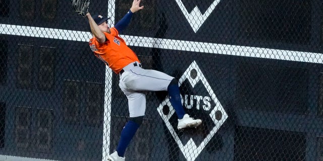 Houston Astros left fielder Chas McCormick catches a fly ball hit by Philadelphia Phillies' J.T. Realmuto during the ninth inning in Game 5 of baseball's World Series between the Houston Astros and the Philadelphia Phillies on Thursday, Nov. 3, 2022, in Philadelphia.