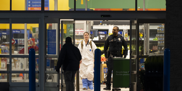 A law enforcement investigator wears a protective covering as they work the scene of a mass shooting at a Walmart in Chesapeake, Virginia. Five adults and one teenage boy were killed, authorities said. 