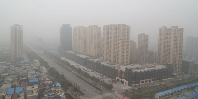 In China's city Tai'an, an attempted bank robbery began around noon on Tuesday and local police shot the suspect and freed the hostage he had taken. Police said no one else was harmed. Pictured: Heavy smog covering the city buildings on Nov. 10, 2015, in Taian, Shandong Province of China. 